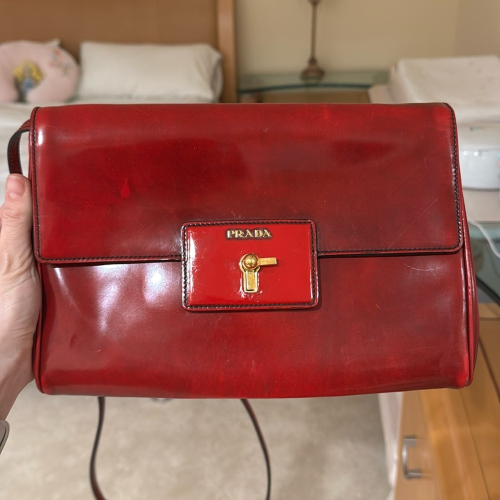 Prada red patent leather bag/clutch with removable and adjustable strap.